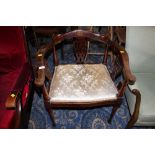 An Edwardian mahogany inlaid corner armchair having floral upholstered seat