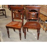 A pair of late Victorian mahogany chairs, with crested rails,