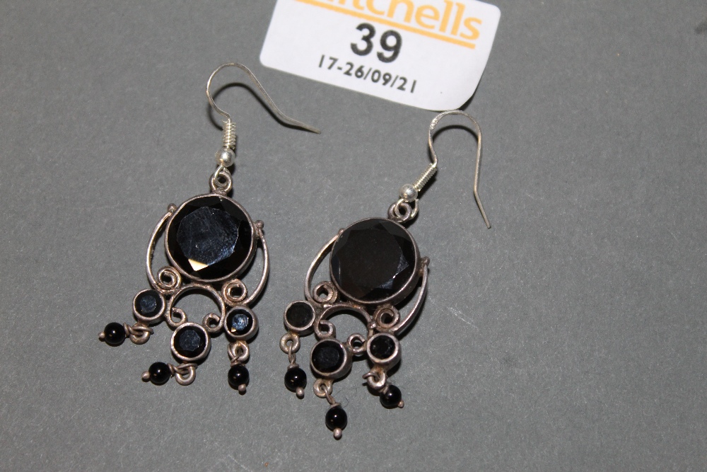 A pair of white metal and black onyx pendant earrings