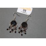 A pair of white metal and black onyx pendant earrings
