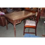 An oak rectangular desk with leather writing surface and raised on turned legs measuring 70 cm tall