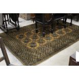 An eastern fringed rug woven in brown and with repeating geometric design measuring 270 cm long 184