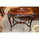 An Edwardian mahogany inlaid occasional table raised on shaped legs and terminating in castors,