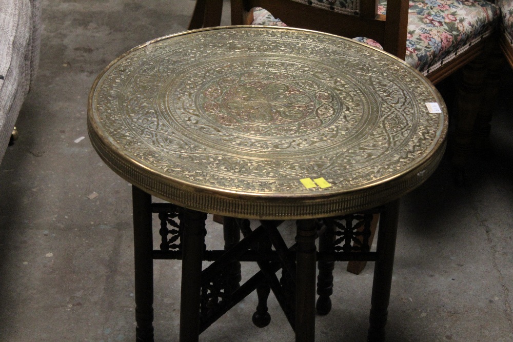 An eastern brass tray topped table