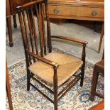 A 19th century oak carved bedroom chair with rush seat