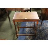 An oak rectangular occasional table raised on turned legs