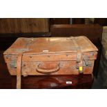 A vintage tan leather suitcase