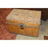 A mustard coloured tin trunk with carrying handles measuring 42 cm tall x 64 cm wide