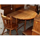 A pine drop leaf and gate leg table together with two pine spindle back dining chairs