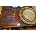 A late 19th century carved oak panel, together with lacquered circular dish,
