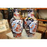 A pair of oriental baluster shaped vases with character marks to the base