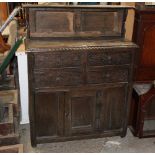 An oak carved sideboard with raised back,