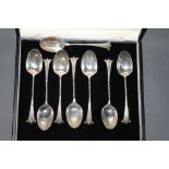 A set of 8 Victorian silver teaspoons with scalloped bowls and scrolled terminals London 1888