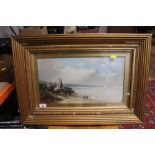 A gilt framed oil painting of a coastal scene