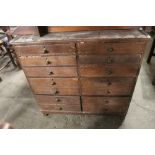 A 19th century stained pine flight of 14 drawers measuring 76 cm tall x 78 cm wide