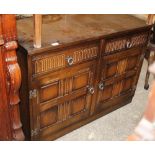 A Priory oak carved sideboard with 2 drawers and 2 cupboards,