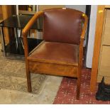 An early 20th century commode chair with lift up seat