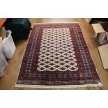 A Tekke Turkoman style rug, woven in red, blue, and cream,