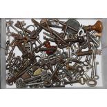 A box of mixed keys together with a long case clock winding handle