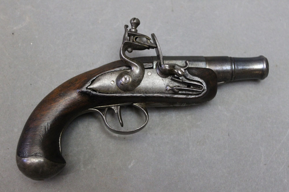 * A flintlock pocket pistol, with cannon shaped 1 1/2" screw off barrel. Overall length 16 cm.