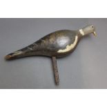 An early 20th century wooden pigeon decoy, with metal stake. Length 36 cm.