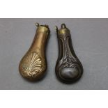 * Two embossed pistol flasks, 11 cm.