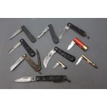 Ten folding pocket knives, three in the form of ammunition, 12 bore cartridge and rifle cartridges,