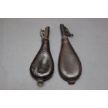 * Two leather bodied shot flask, one embossed with hanging game,