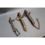 * Three gin traps, one possibly marked J Wild & Son 50, 28 cm, 27 cm & 22 cm.