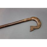 A hazel shafted walking stick, with a carved wooden burr handle in the form of a fish.