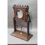 A Victorian magnifying stand, made from oak with an adjustable mirrored back. Height 67 cm.