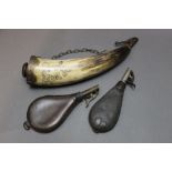 * A large powder horn with pen and ink decoration, 37 cm together with two shot flasks, 20 cm.