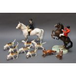 Beswick huntsman on rearing horse, together with a collection of second version fox hounds,