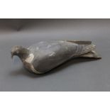 An early to mid 20th century carved wooden pigeon decoy. Length 35 cm.