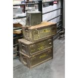 Three metal military ammunition crates.