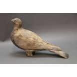 An early to mid 20th century carved wooden pigeon decoy,