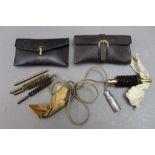 * Two leather pouches containing cleaning equipment,