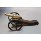 * A miniature cannon, the cannon barrel measuring 4 1/4". Overall length 25 cm.