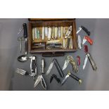 A box containing +/- thirty five folding pocket knives, scissors etc,