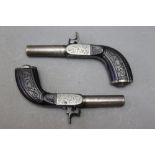 * A pair of steel percussion pocket pistols, with 2 1/2" barrels and fold down triggers,