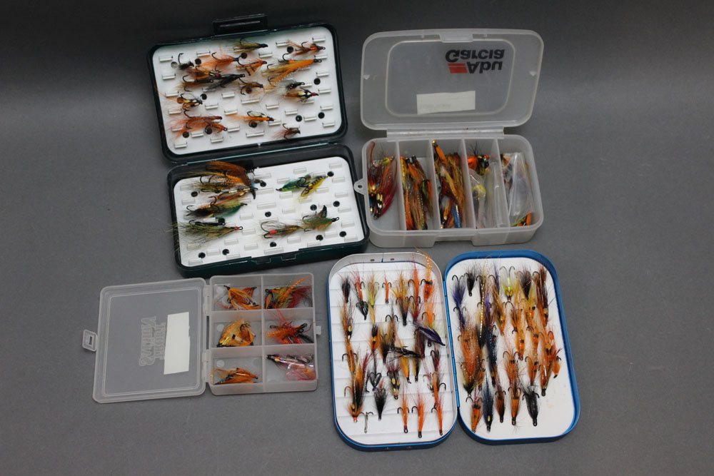 Four fly boxes, tubs of salmon flies.