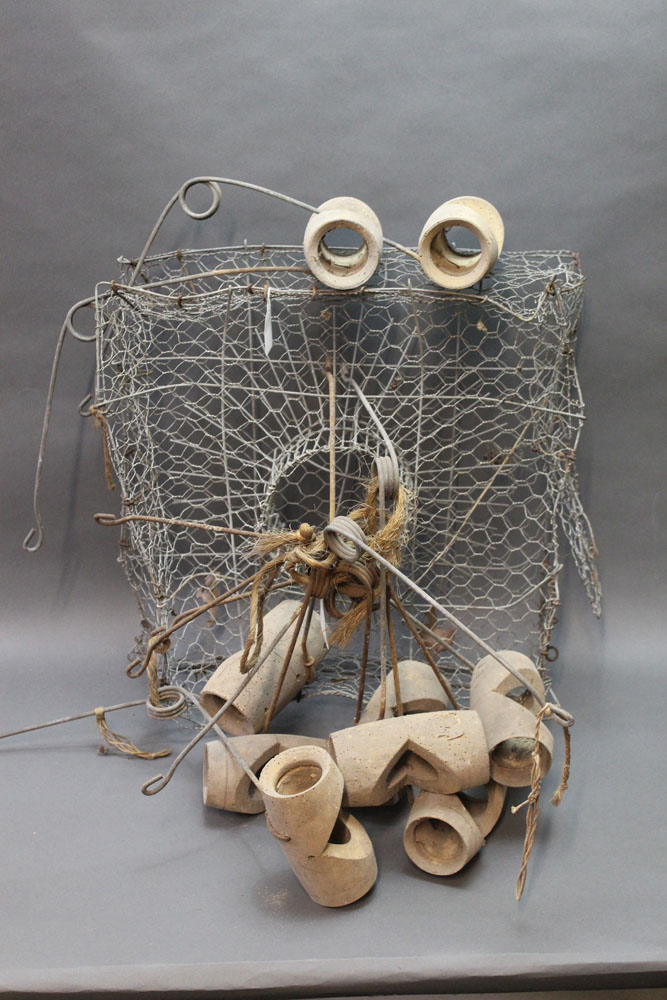 Nine vintage wooden mole traps, together with a crayfish trap.