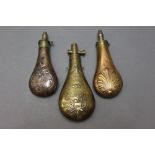 * Three powder flasks, one stamped US in a shield with eagle and clasped hands, length 23 cm,
