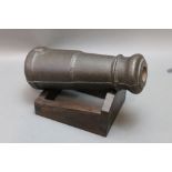 * A cast iron cannon on later stand. Length +/- 36 cm.