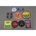 * Nine cloth badges, to include Gamebore, Trawden Clay Pigeon Club,