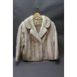 A ladies short mink coat, Size 12/14.