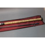 A Daiwa Graphite salmon spinning rod, in two sections, 11'.