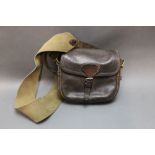 A leather cartridge bag initialled KASS,