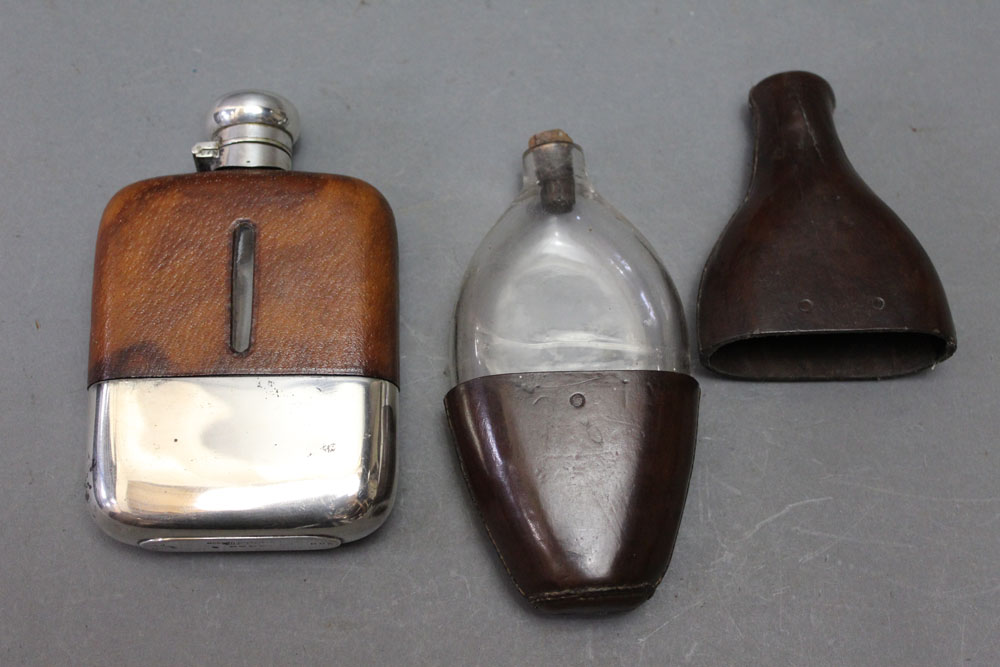 * Two hip flasks, the first by Dispatch marked 8oz with a silver plated bottom and leather top,