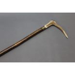 A hazel shafted walking stick with metal collar and stag antler handle. Length 123 cm.